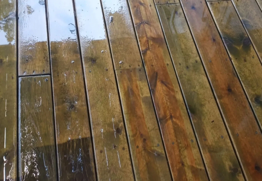 power washing a wooden deck in progress